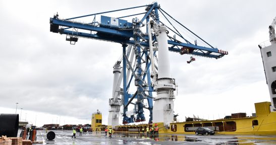 Crane lashed to ship deck embarks from Port of Bilbao bound for the Caribbean